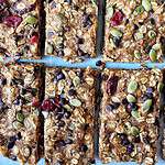 Homemade energy bars with oats, dried cranberries, pumpkin seeds, and chocolate chips, nutrition-rich snack, healthy homemade treat.