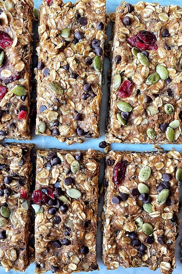 Homemade energy bars with oats, dried cranberries, pumpkin seeds, and chocolate chips, nutrition-rich snack, healthy homemade treat.