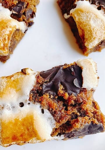 Decadent chocolate chip cookie bars with marshmallow and caramel topping.
