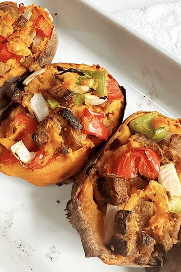 Stuffed sweet potatoes with vegetables and ground meat, healthy and flavorful meal.