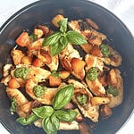 Grilled chicken with roasted vegetables and fresh basil garnished.