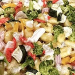 Fresh veggie pasta salad with broccoli, bell peppers, zucchini, and cheese, served cold for a healthy meal.