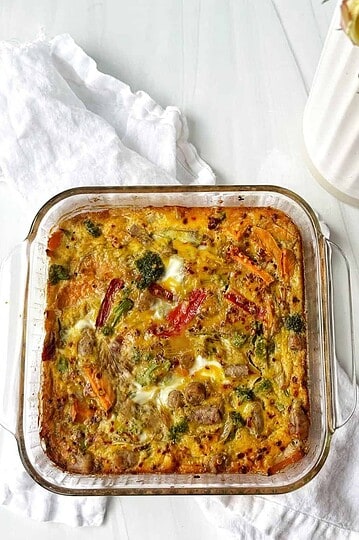 Baked vegetable and chicken casserole in glass dish, healthy homemade meal, from Lesswithlaur.