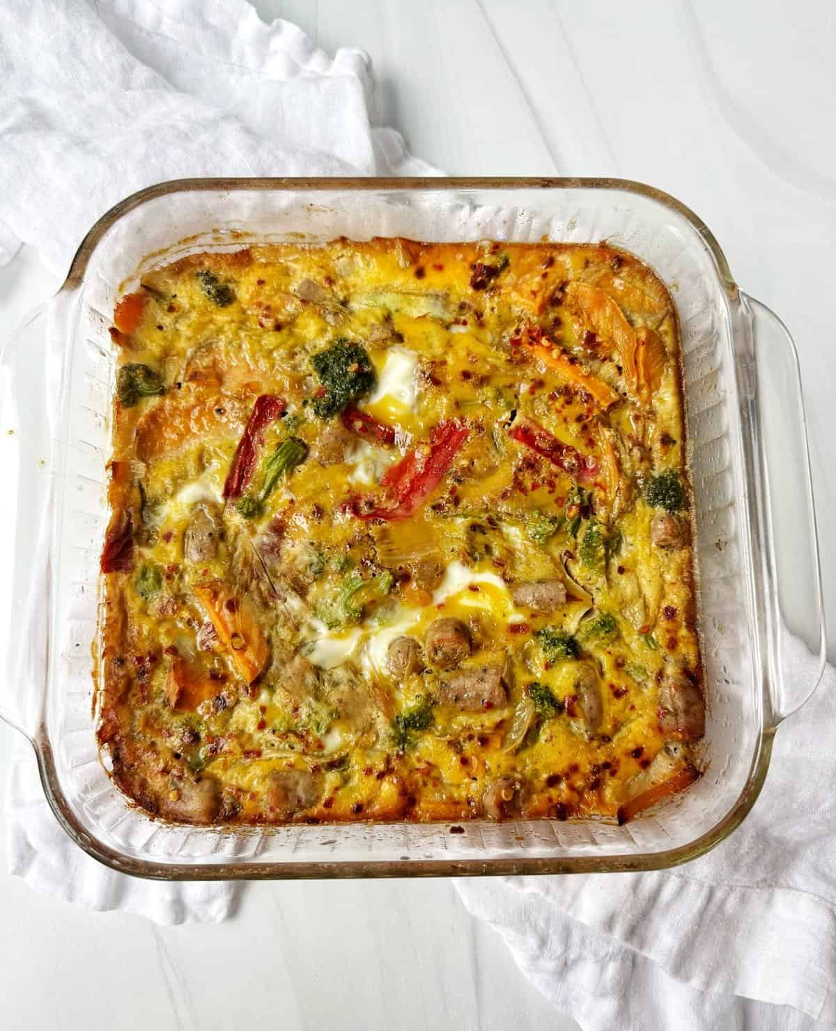 Baked vegetable and meat casserole in glass dish, home-cooked comfort food.