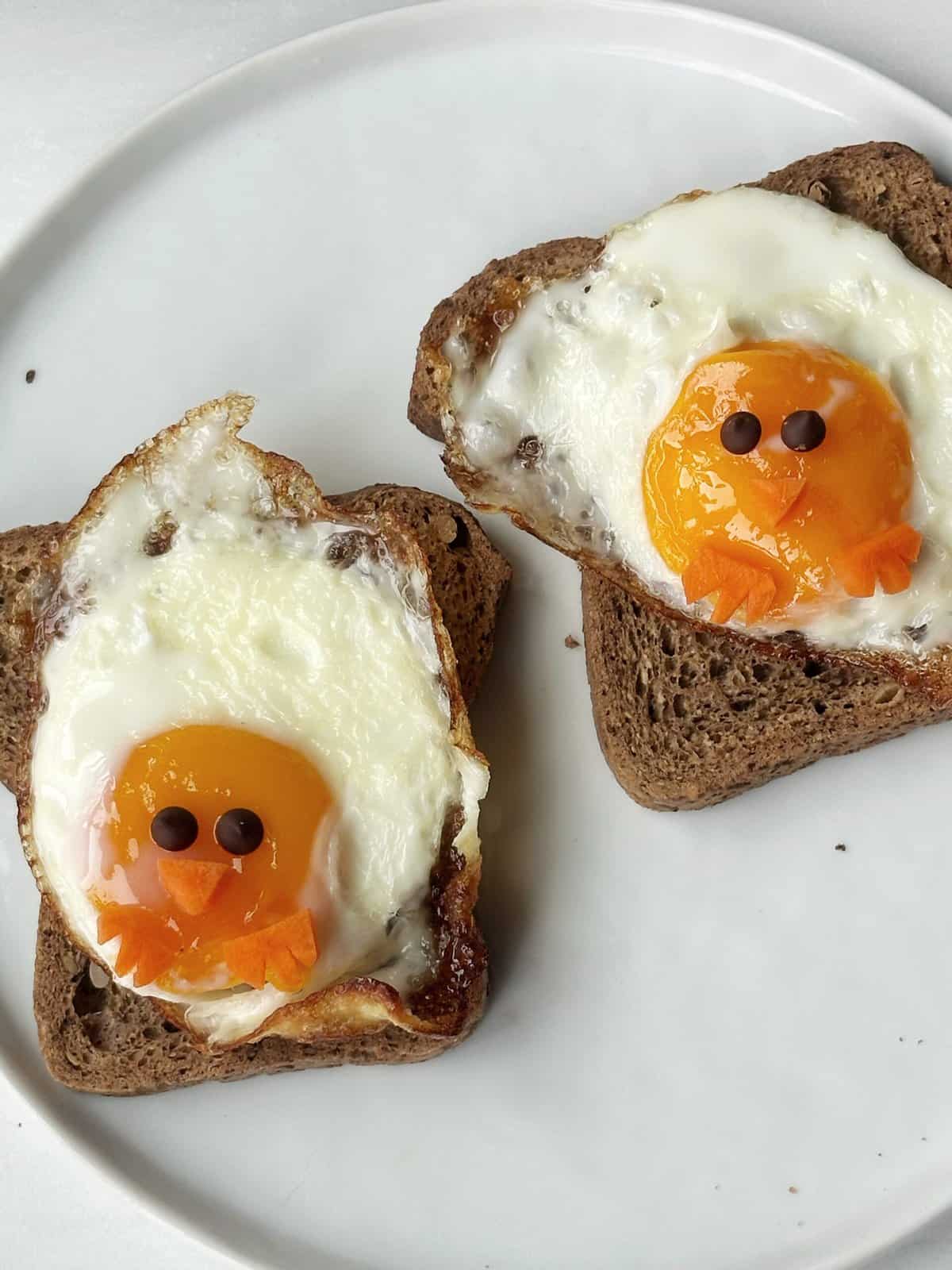 eggs on toast in the shape of chicks with faces