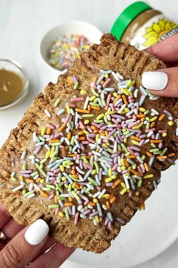Soft baked cookie with colorful sprinkles and a creamy caramel drizzle, perfect for sweet treats and dessert cravings.