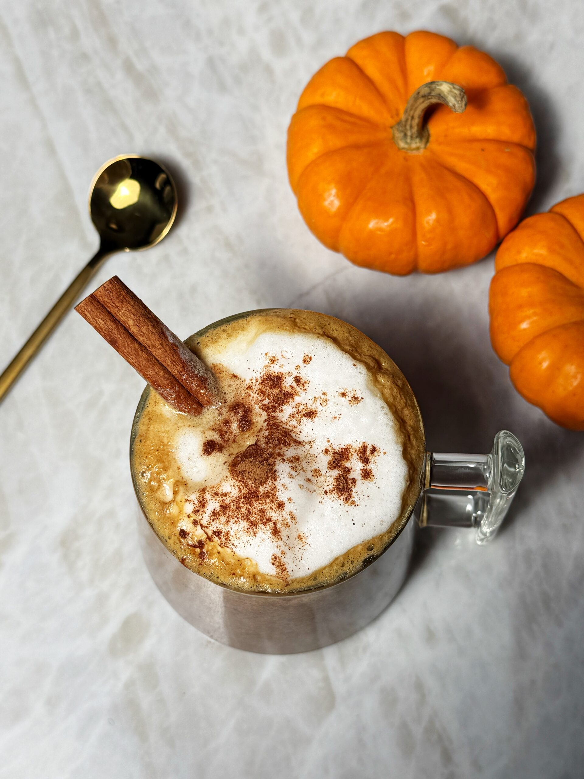 dairy-free pumpkin spice latte next to pumpkins