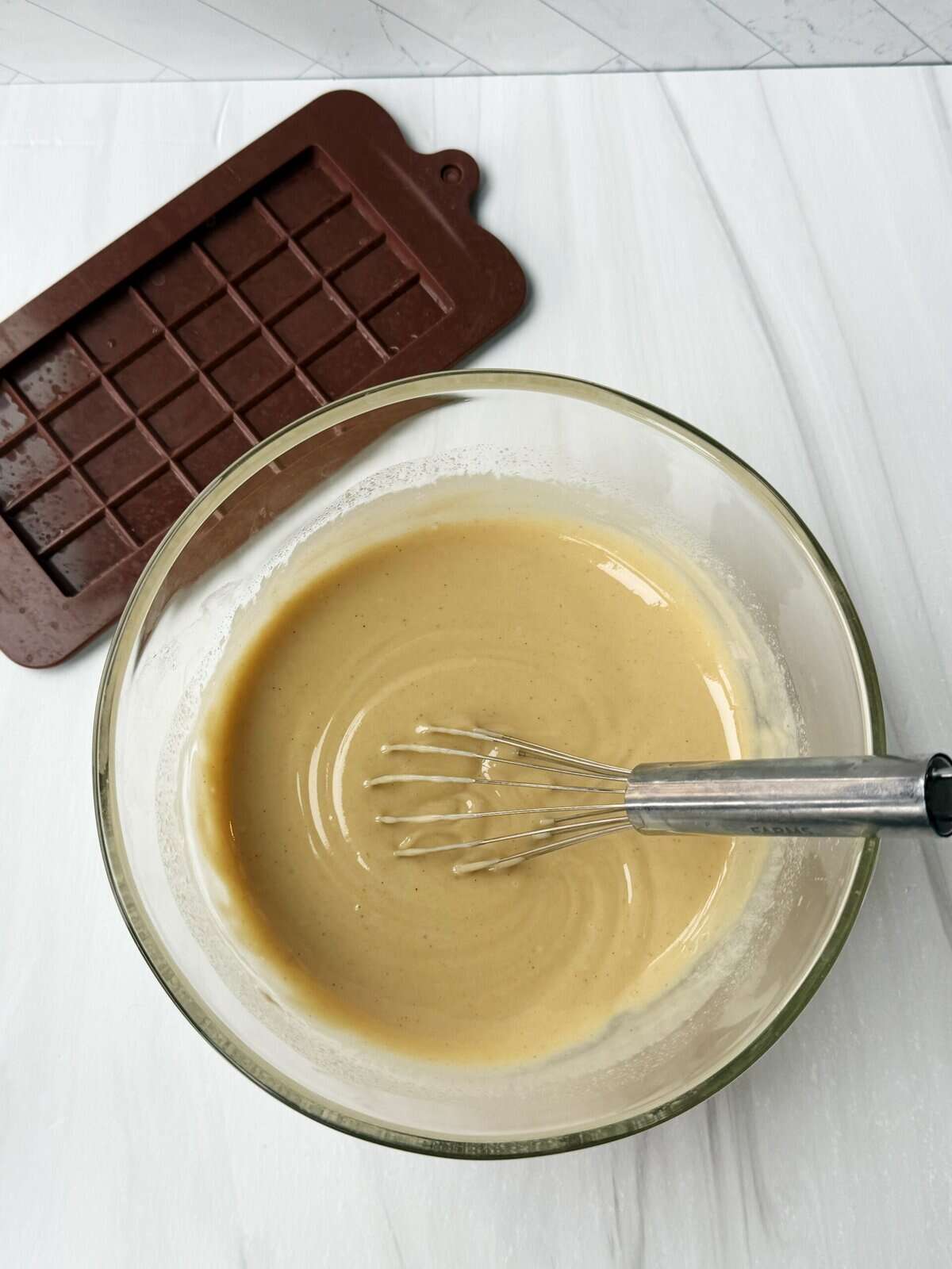 dairy free white chocolate melted in a bowl