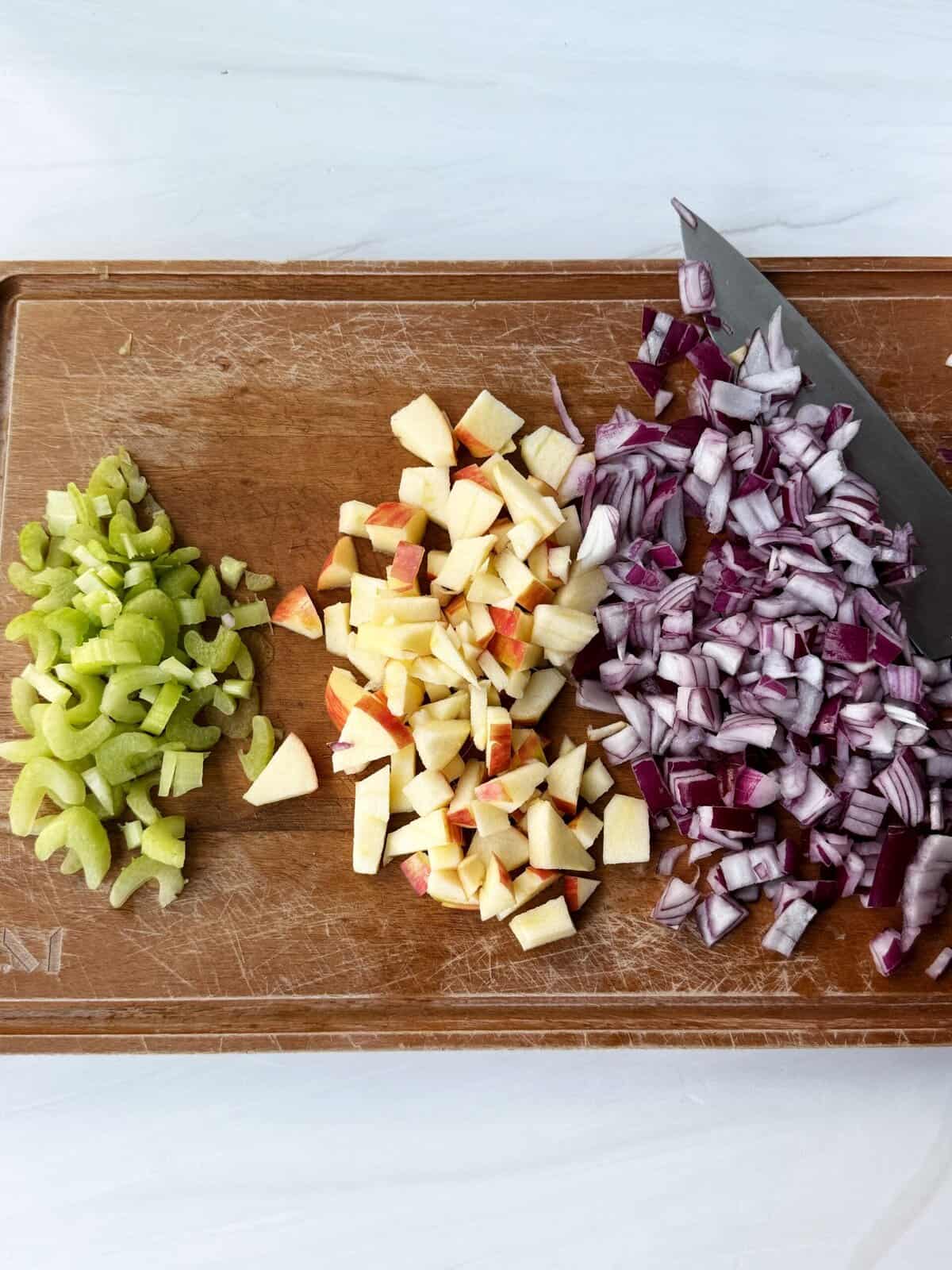 veggies and fruit chopped on a cutting board