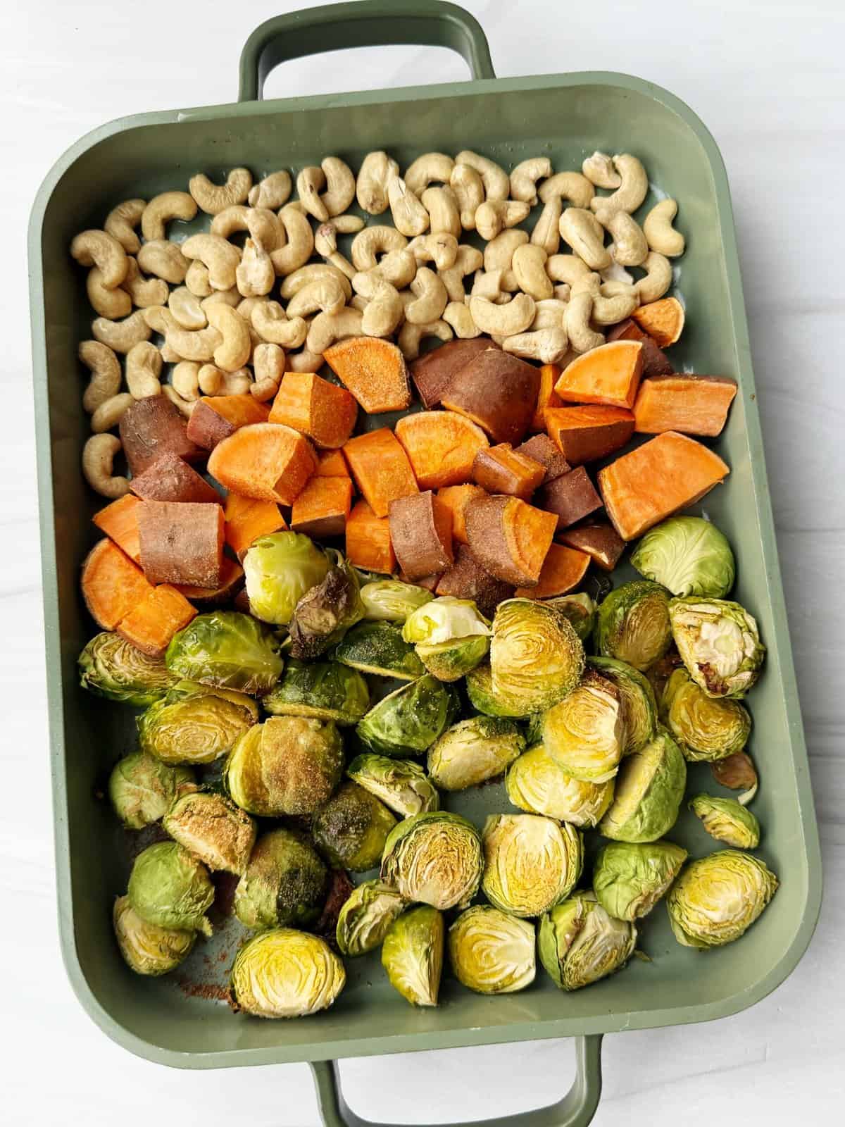 vegetables and cashews on baking sheet