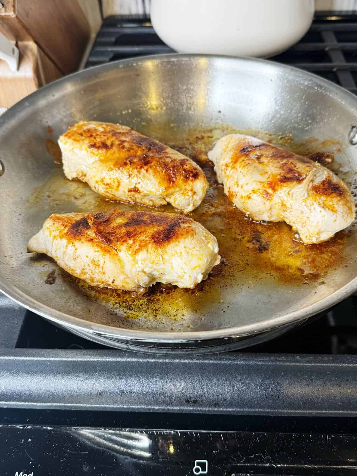 chicken cooking in pan