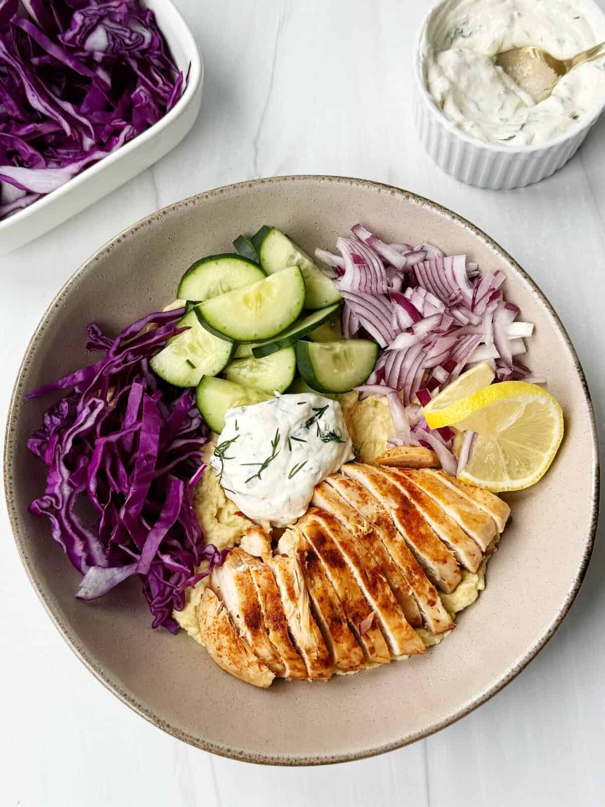 chicken bowl with hummus, veggies and yogurt dip