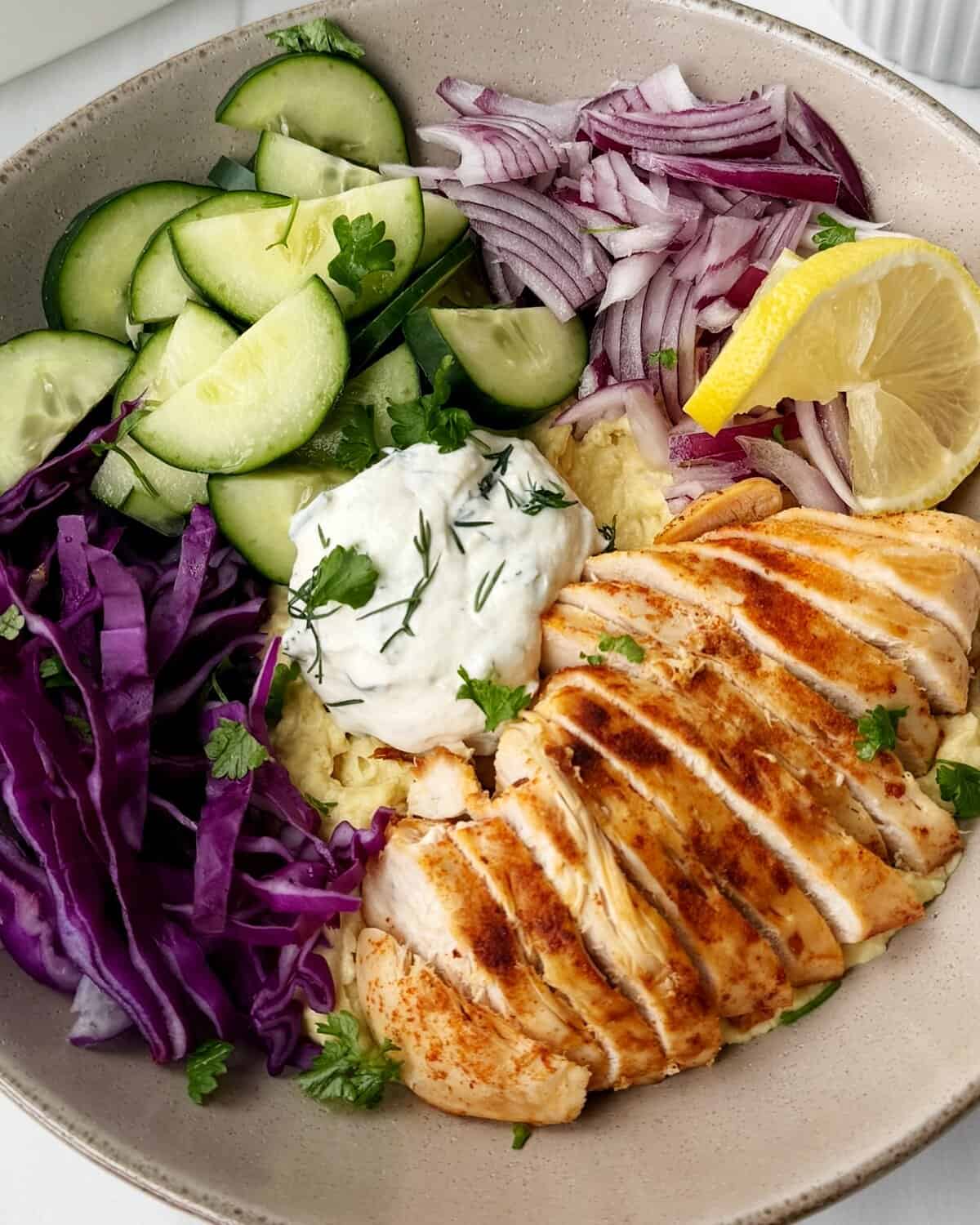 hummus bowl with chicken and colorful veggies