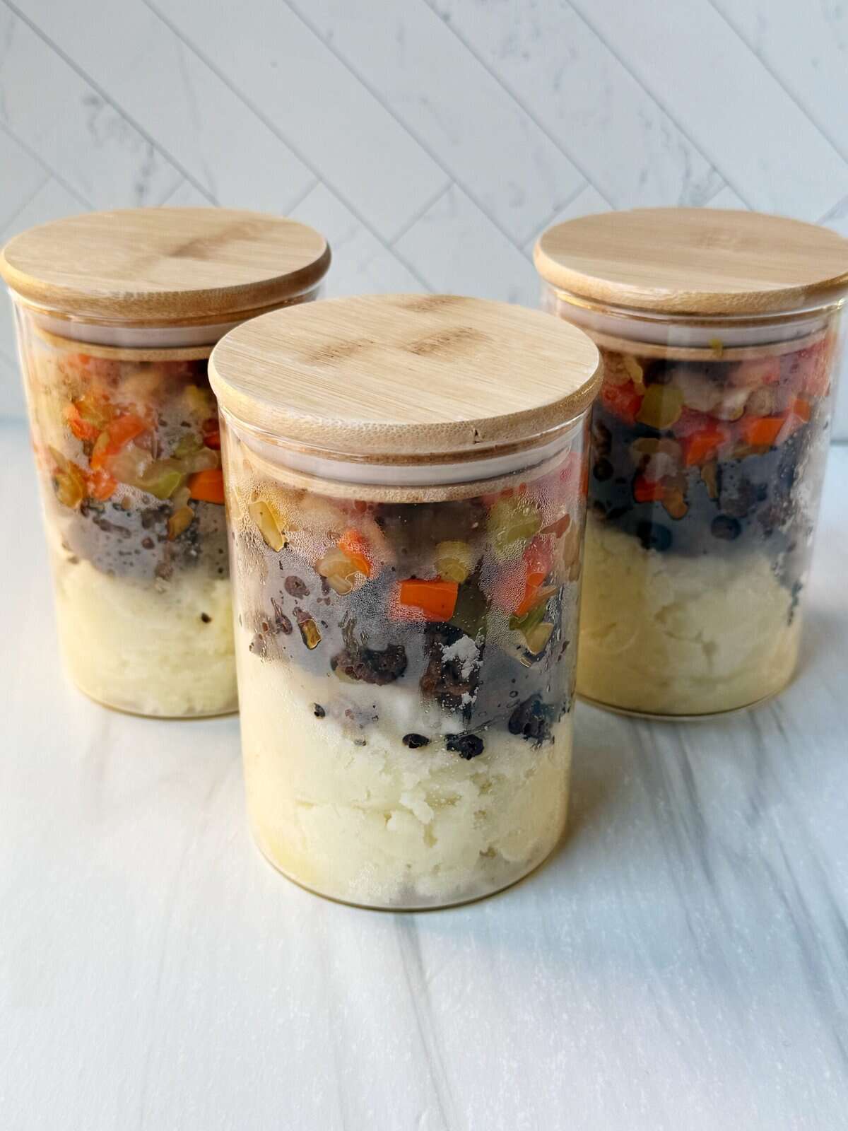 shepherd's pie layered in a glass jar with a bamboo lid