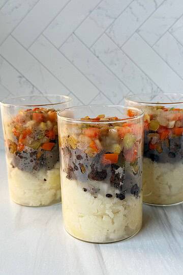 shepherd's pie layered in a jar with mashed potatoes, ground beef and veggies