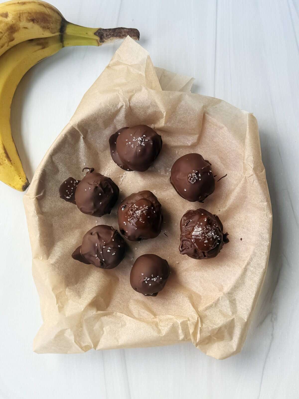 banana bread bites covered in chocolate on a plate