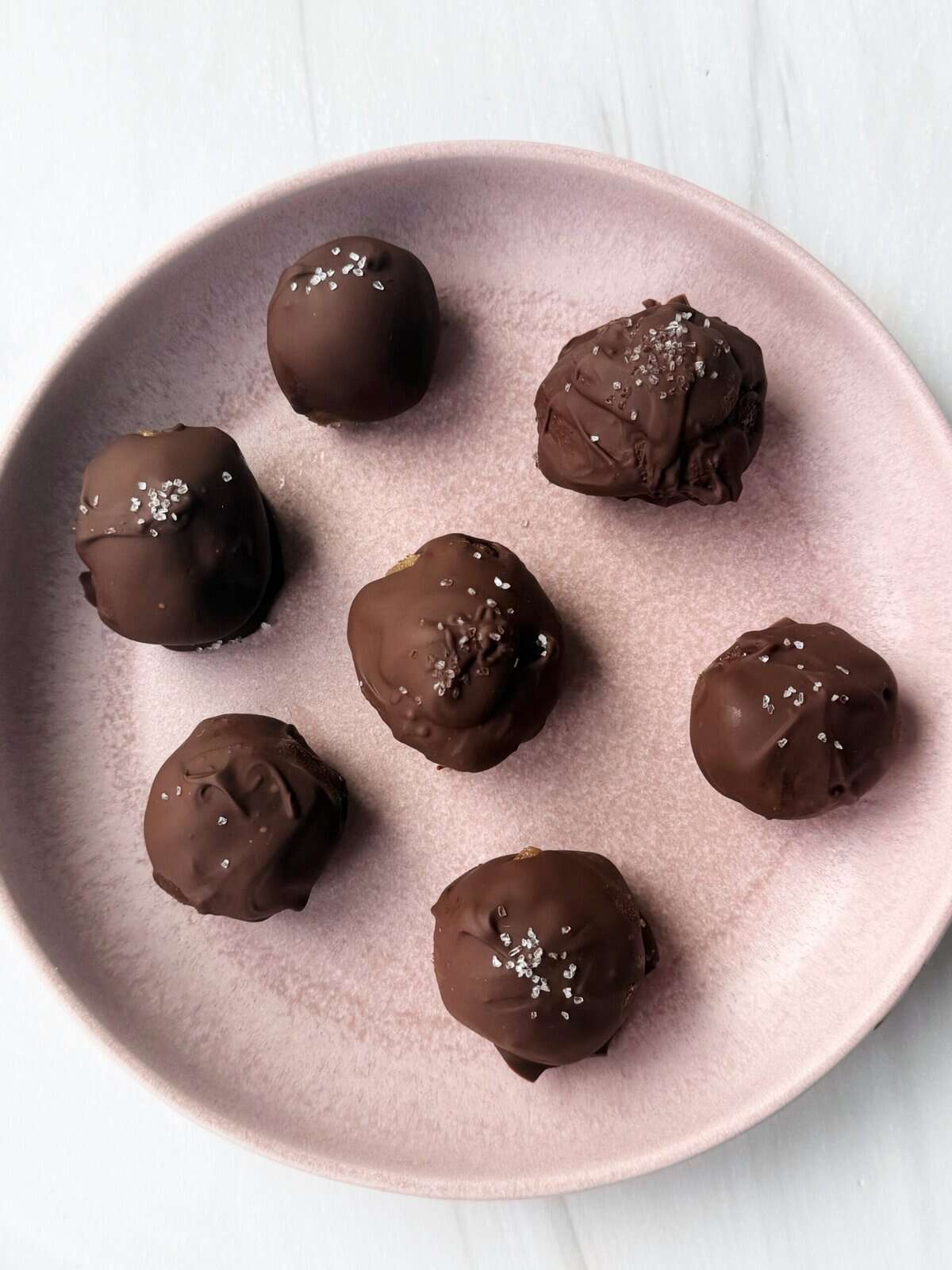 banana bread balls on a pink plate 