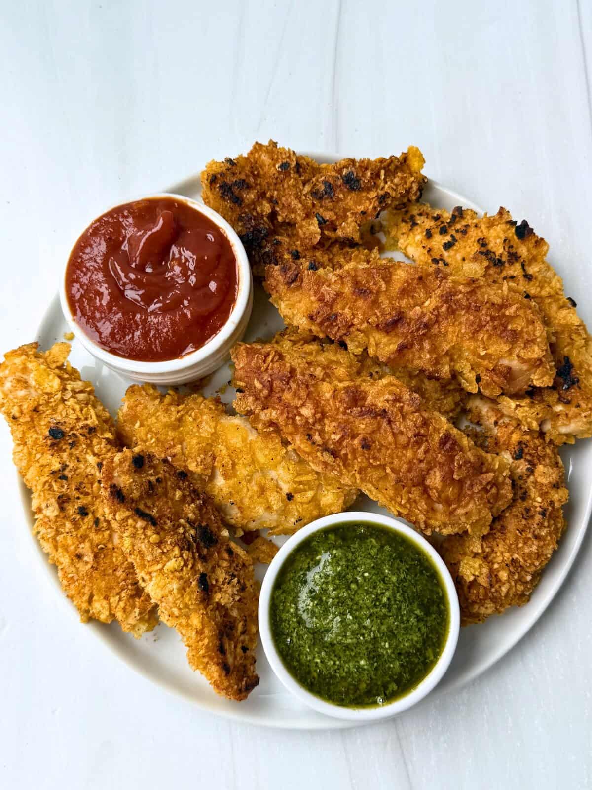 gluten-free chicken tenders with pesto and ketchup dipping sauces 