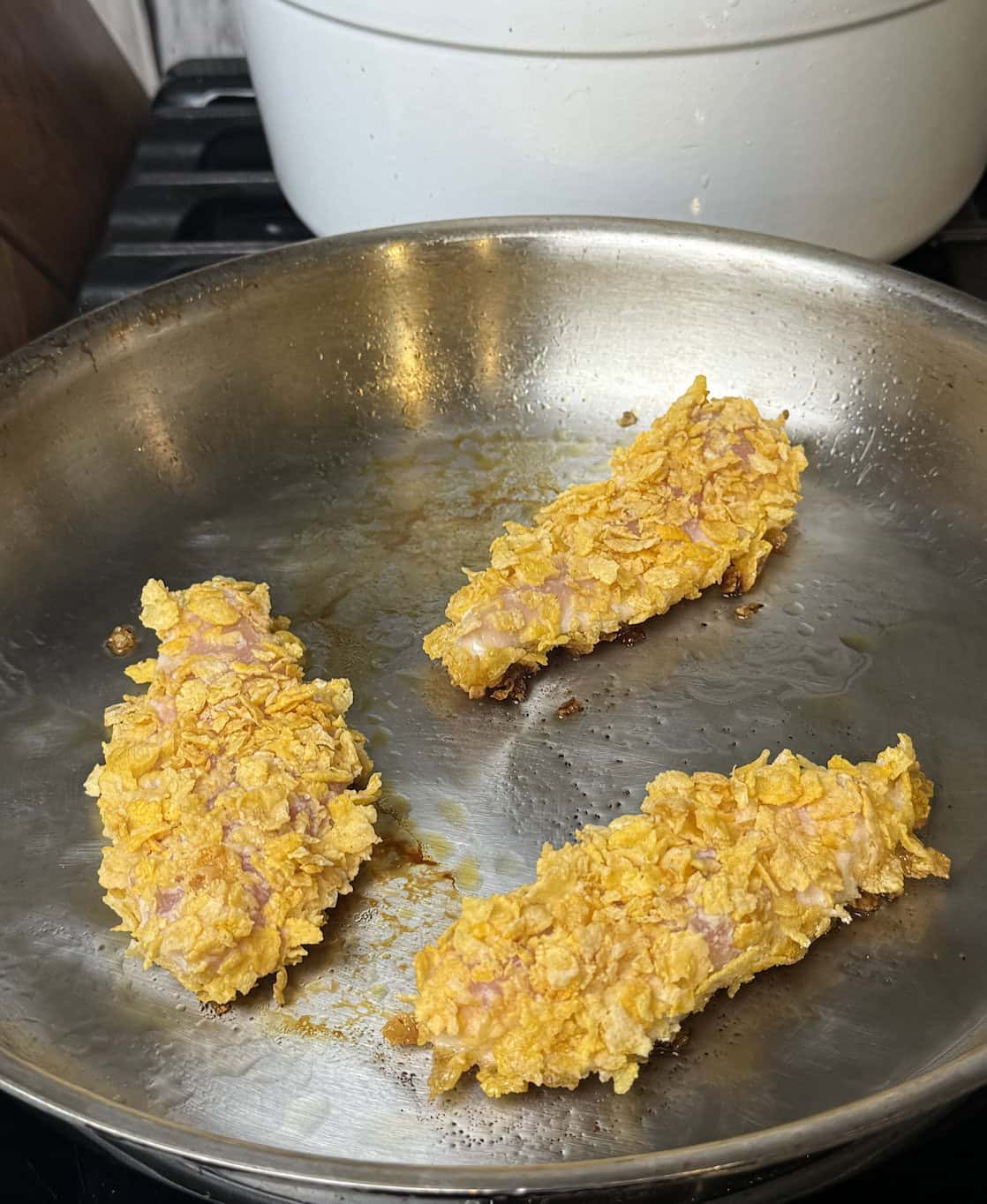 chicken tenders frying in a pan