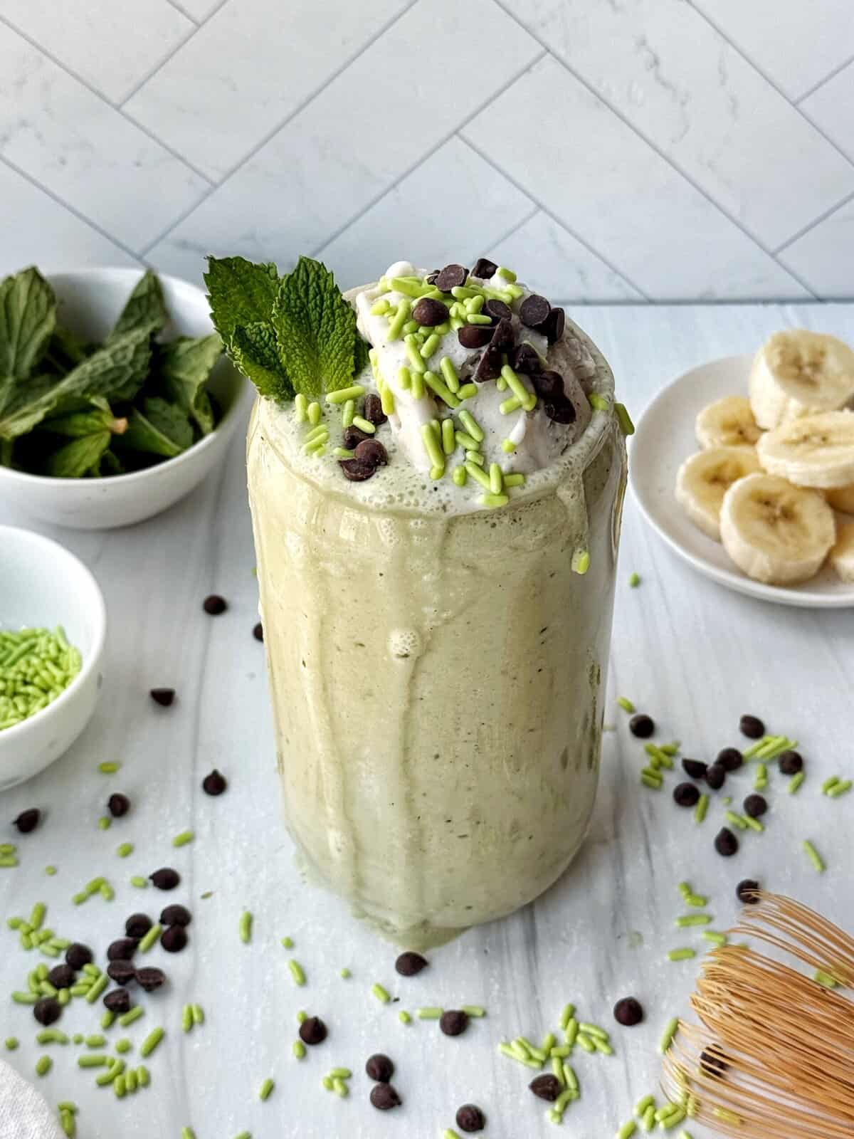 shamrock milkshake topped with fresh mint, whipped cream, sprinkles and chocolate chips 