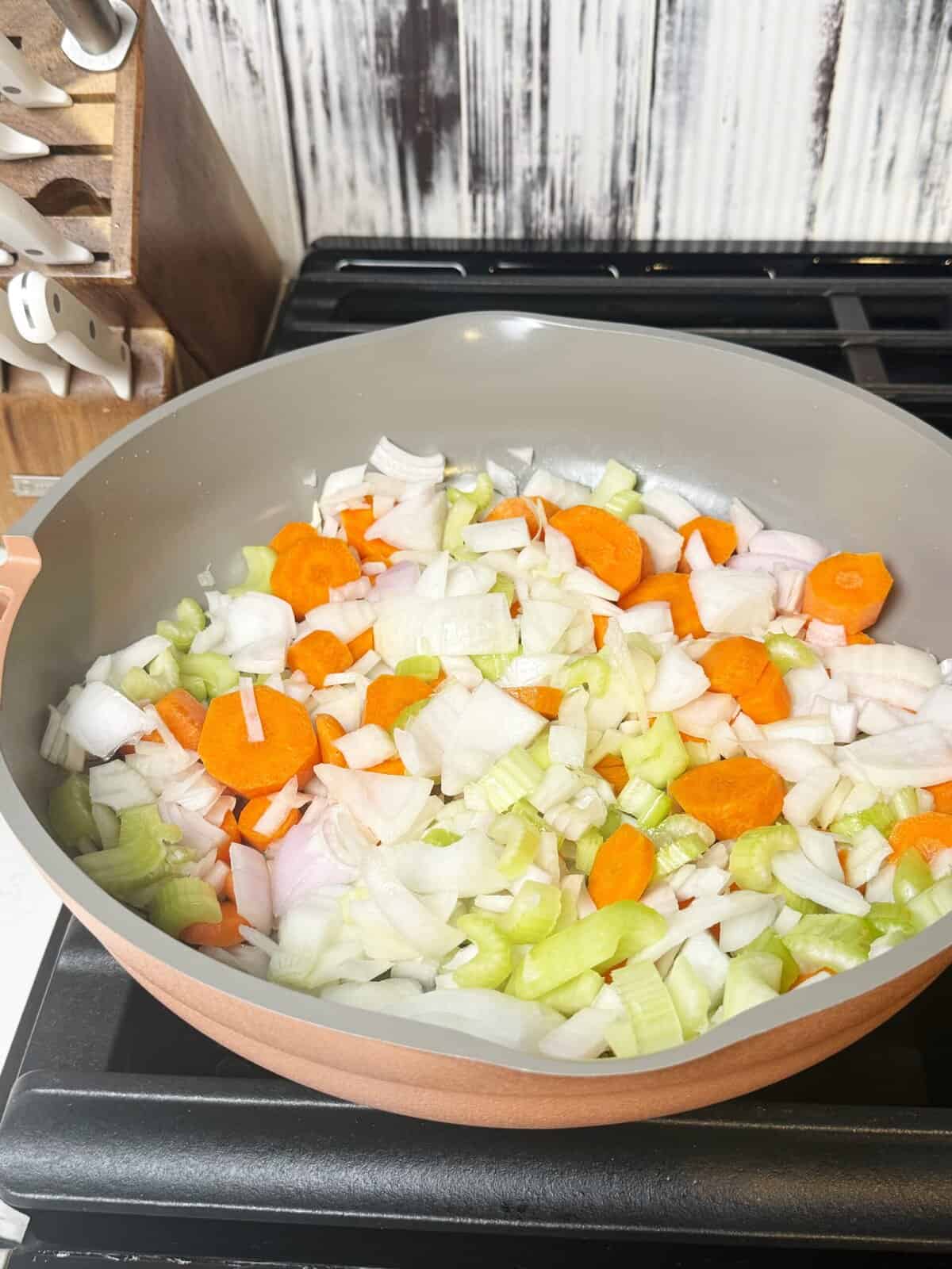 celery, carrots, onion saut&eacute;ing in pan 