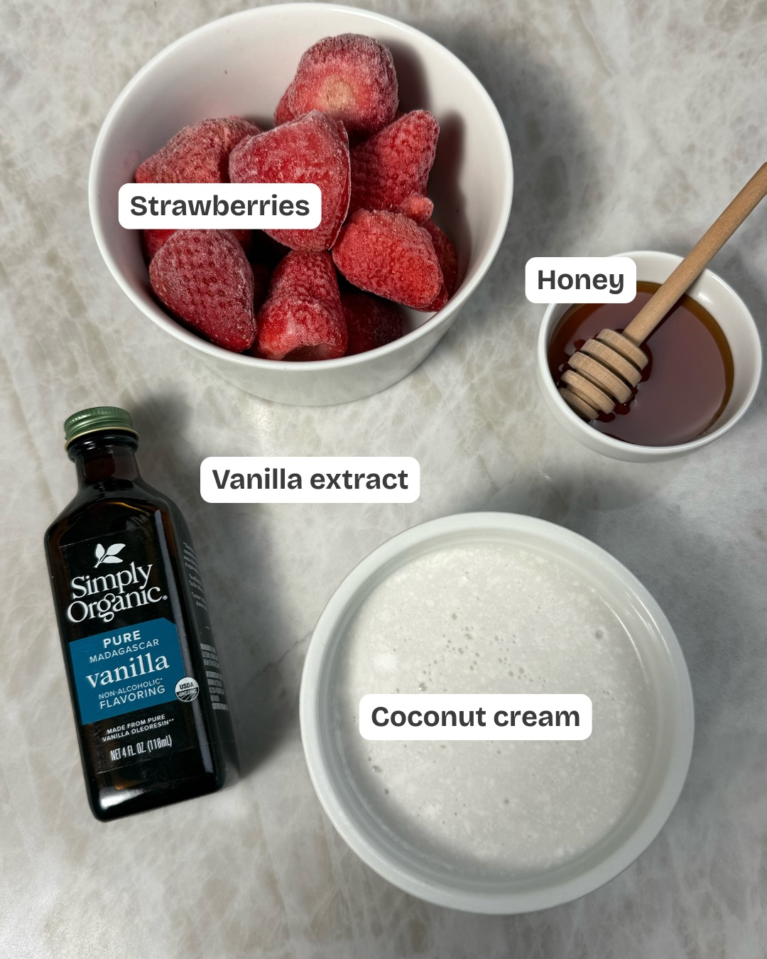 ingredients to make dairy-free strawberry ninja creami ice cream including strawberries, vanilla, coconut cream and honey