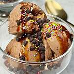 chocolate ninja creami ice cream in a dish with chocolate chips and sprinkles on top