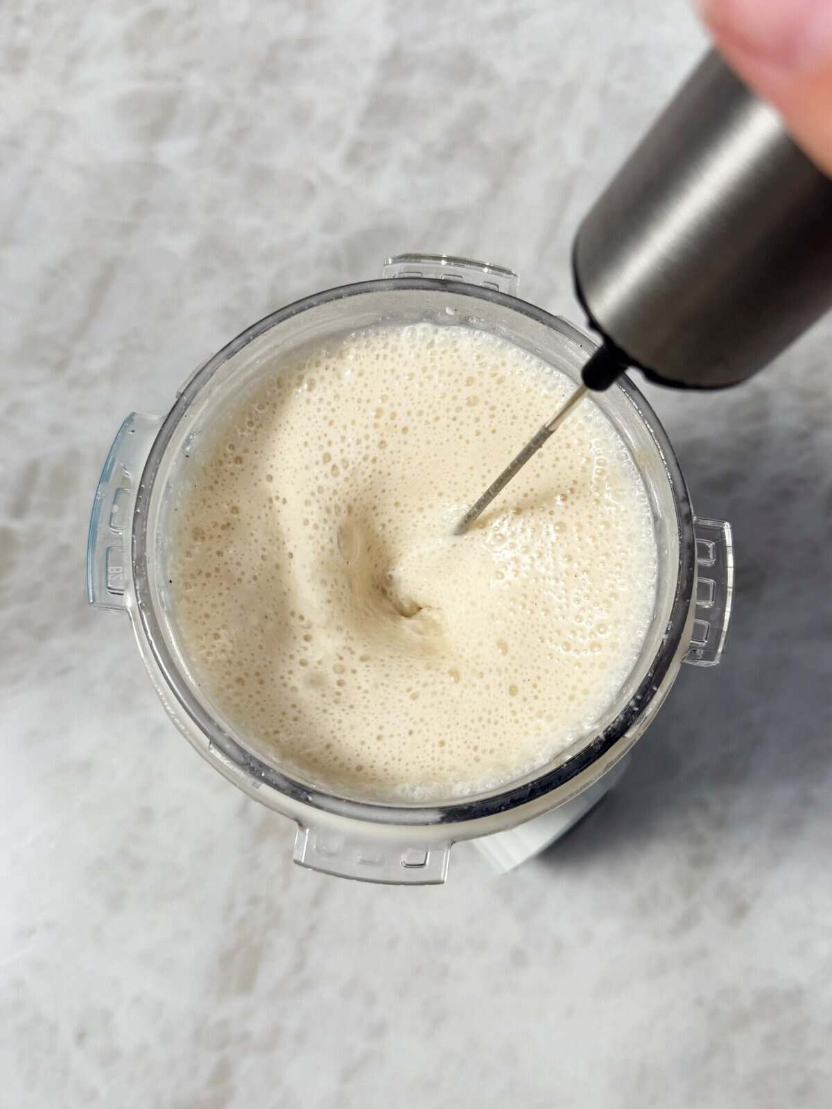 vanilla creami ingredients mixed with a frother