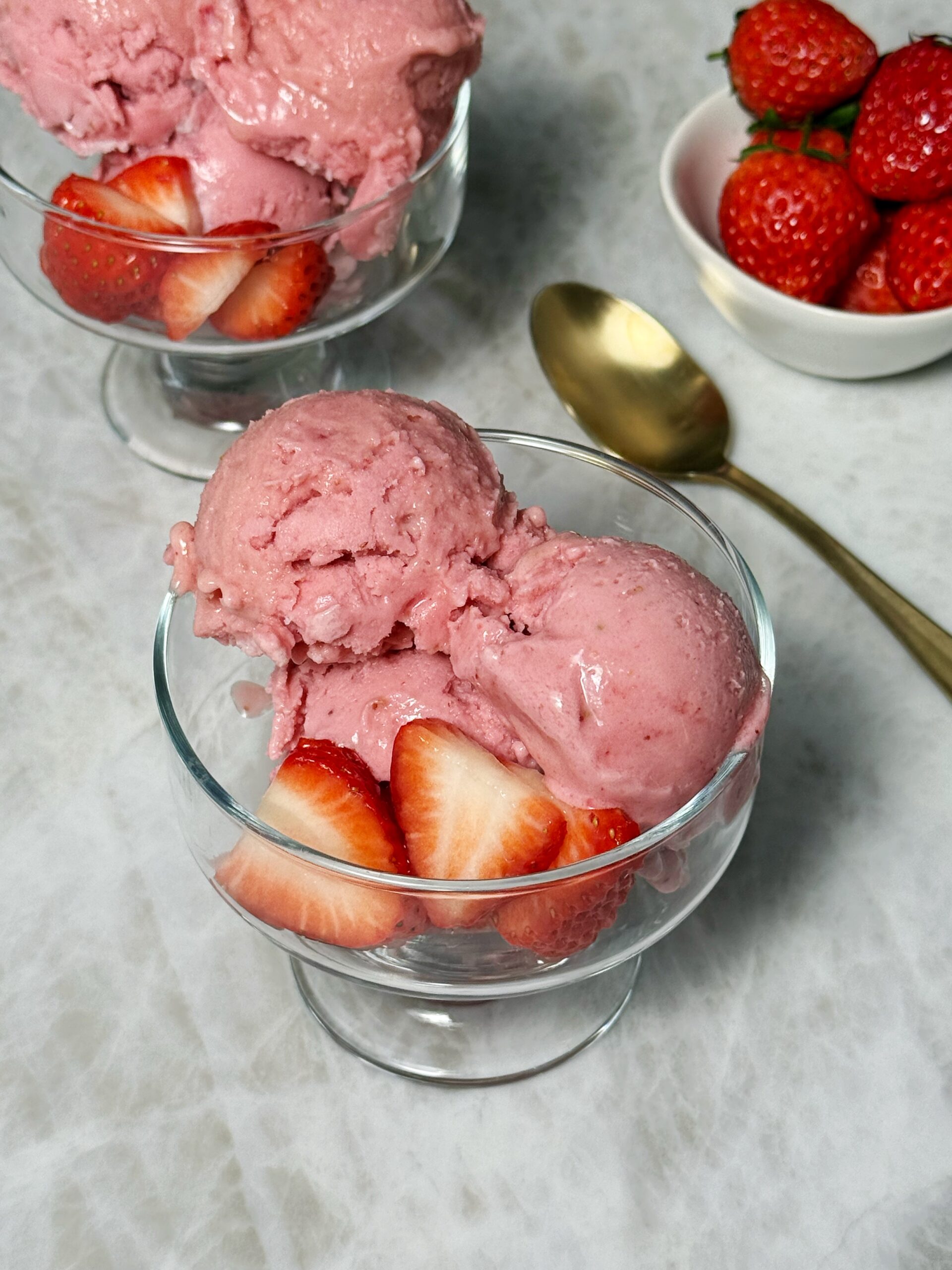 dairy-free strawberry ninja creami with fresh strawberries on top
