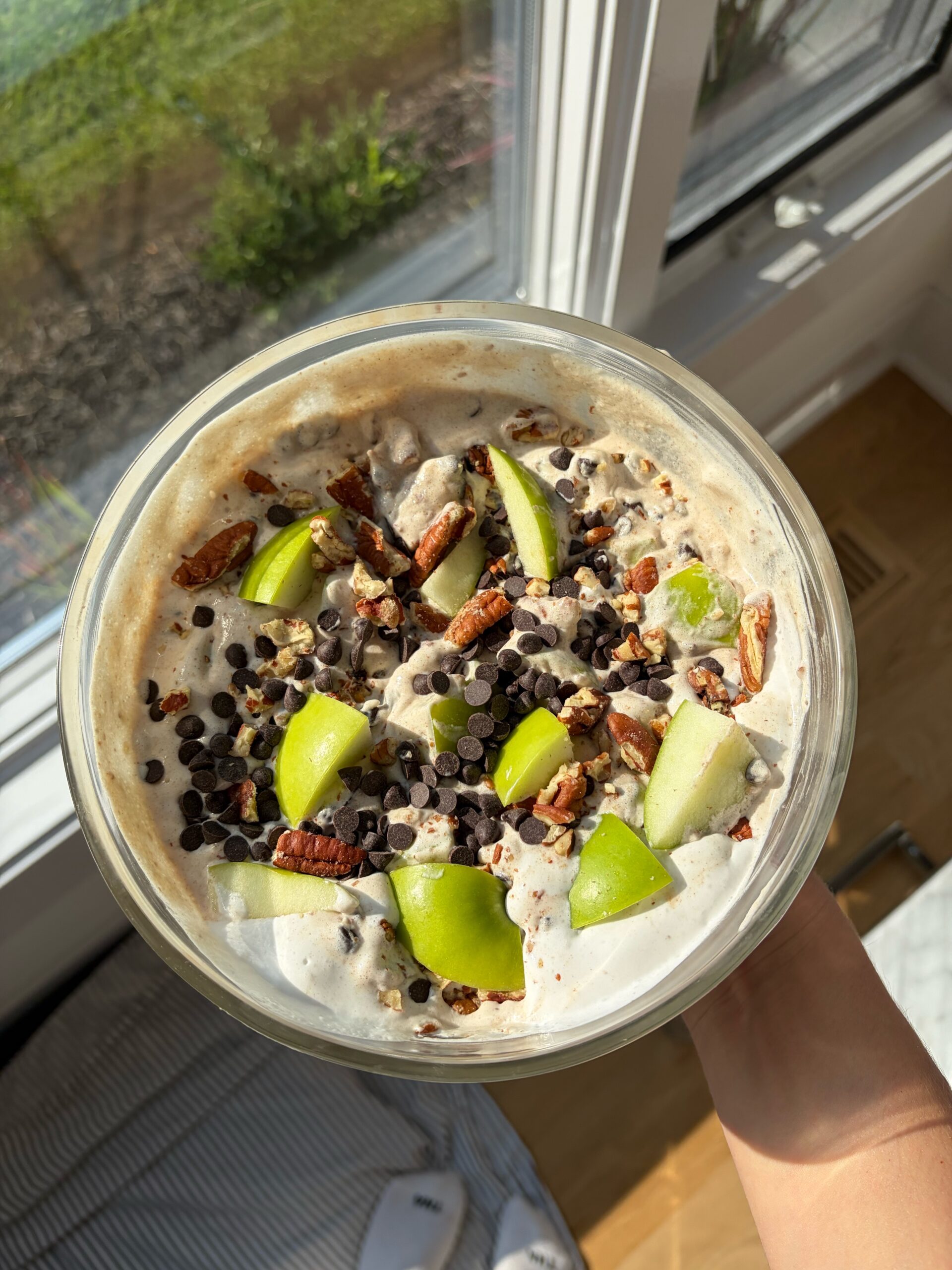 caramel apple salad in a bowl with chocolate chips and pecans on top 