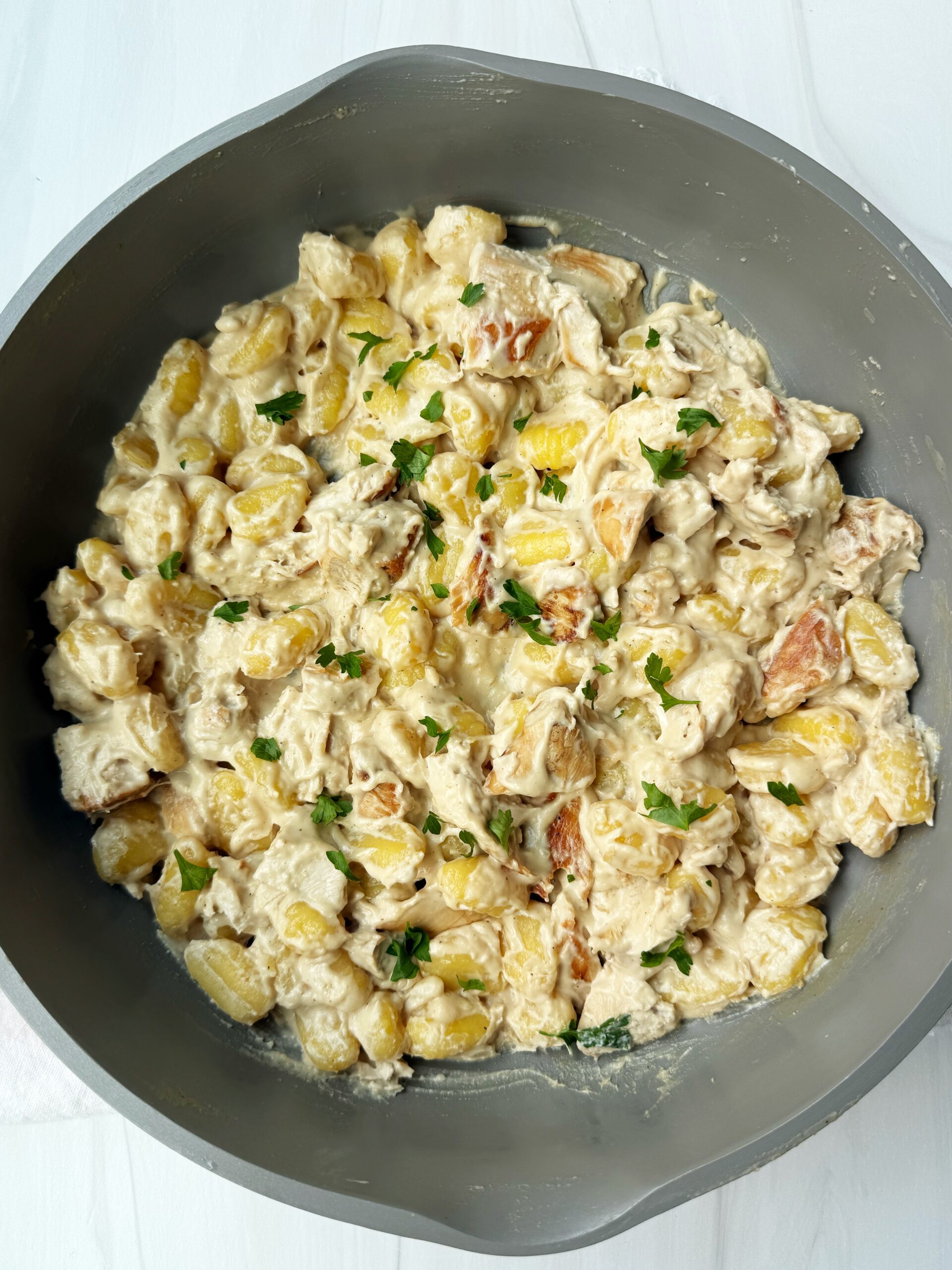 chicken gnocchi alfredo in a pan 
