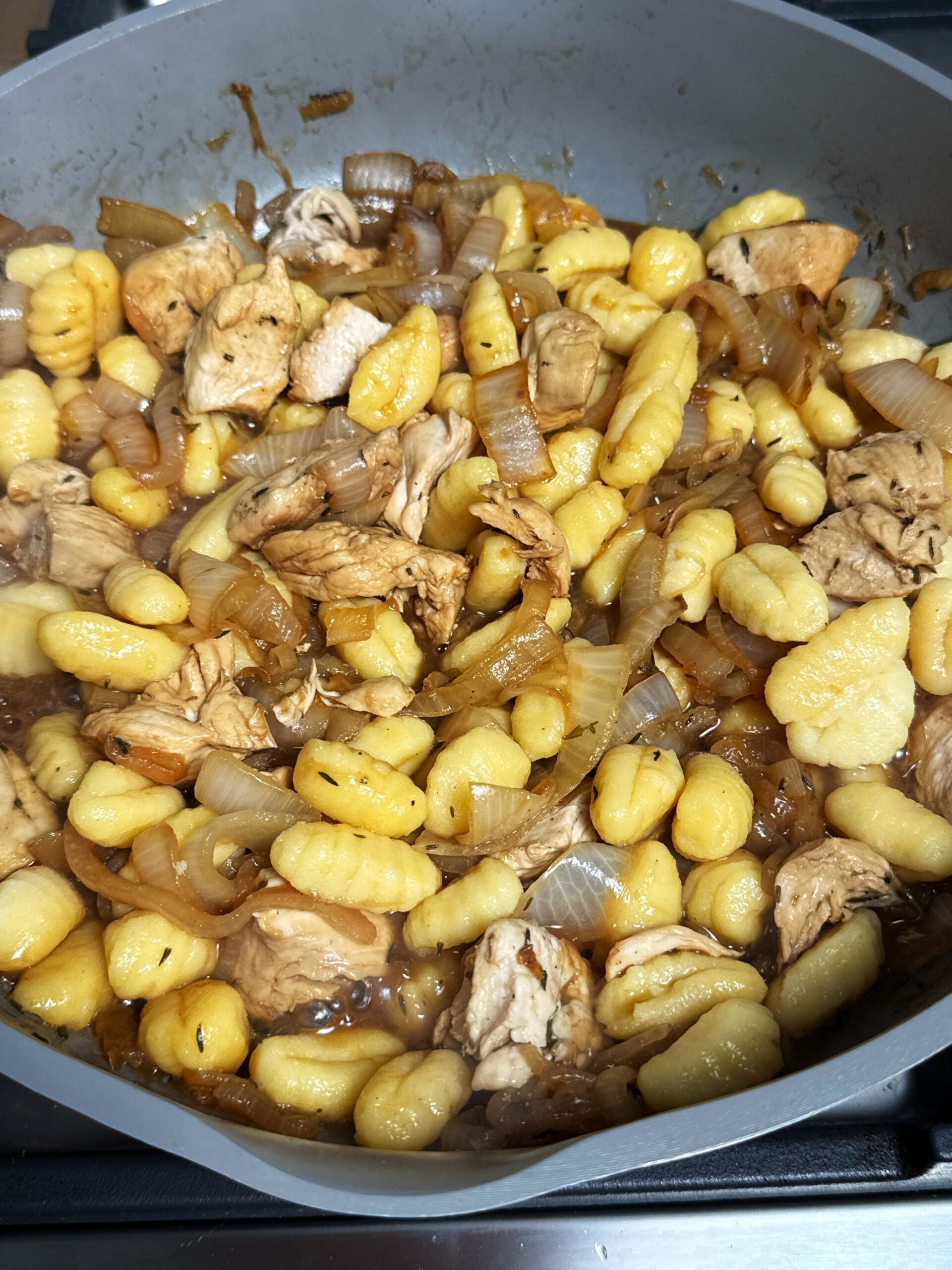 gnocchi, chicken and onions cooking 