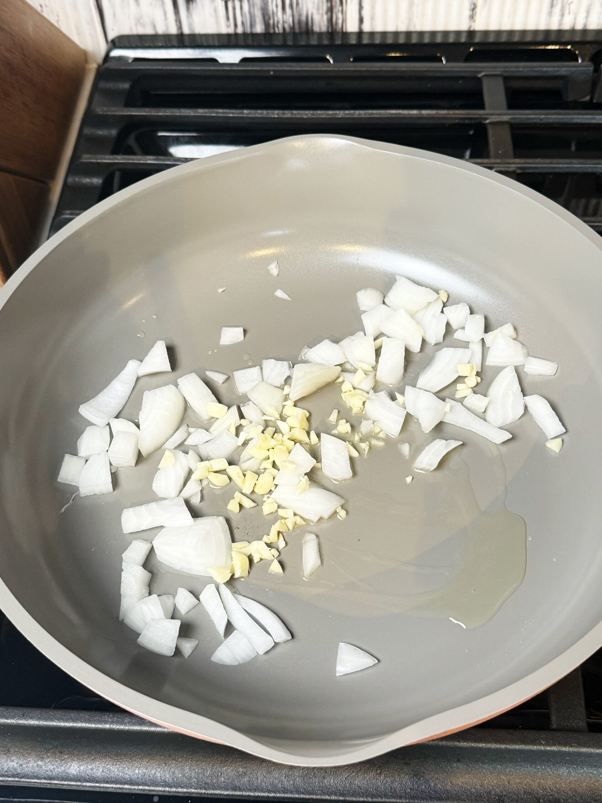 garlic and onion sauteeing in a pan 
