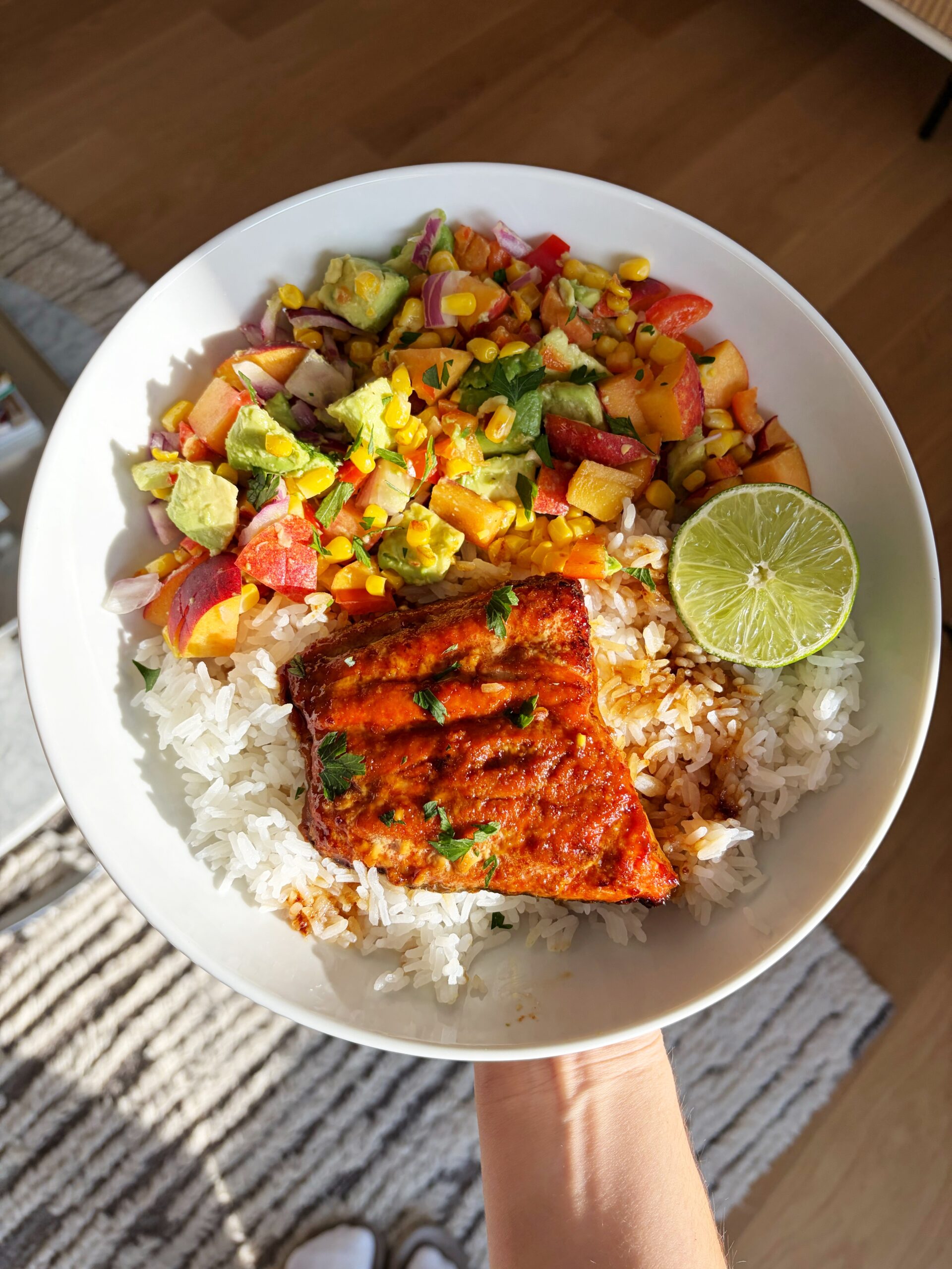 salmon with peach, avocado, corn, red onion and a lime over a bed of coconut rice 
