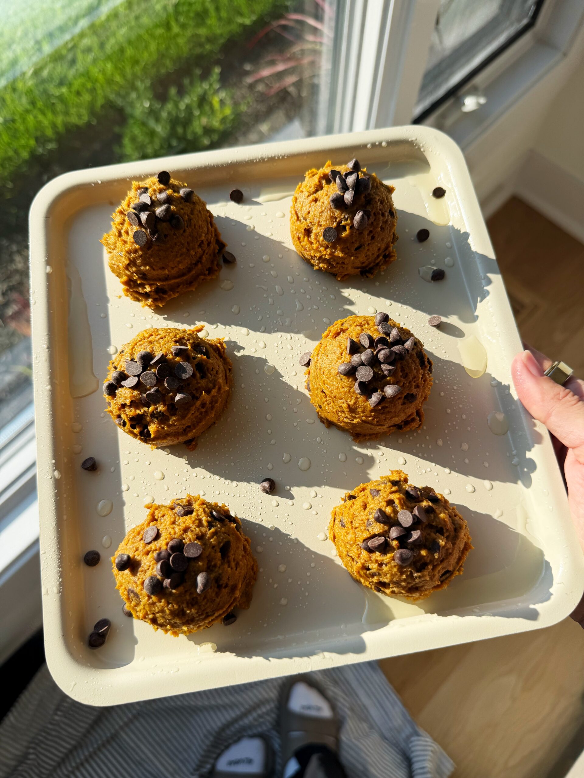 pumpkin cookies with chocolate chips on baking sheet