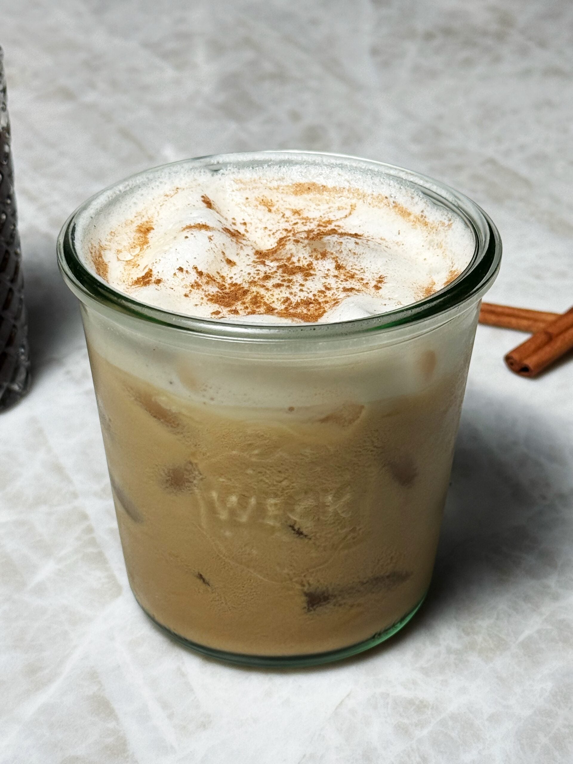 cinnamon roll latte in a glass 
