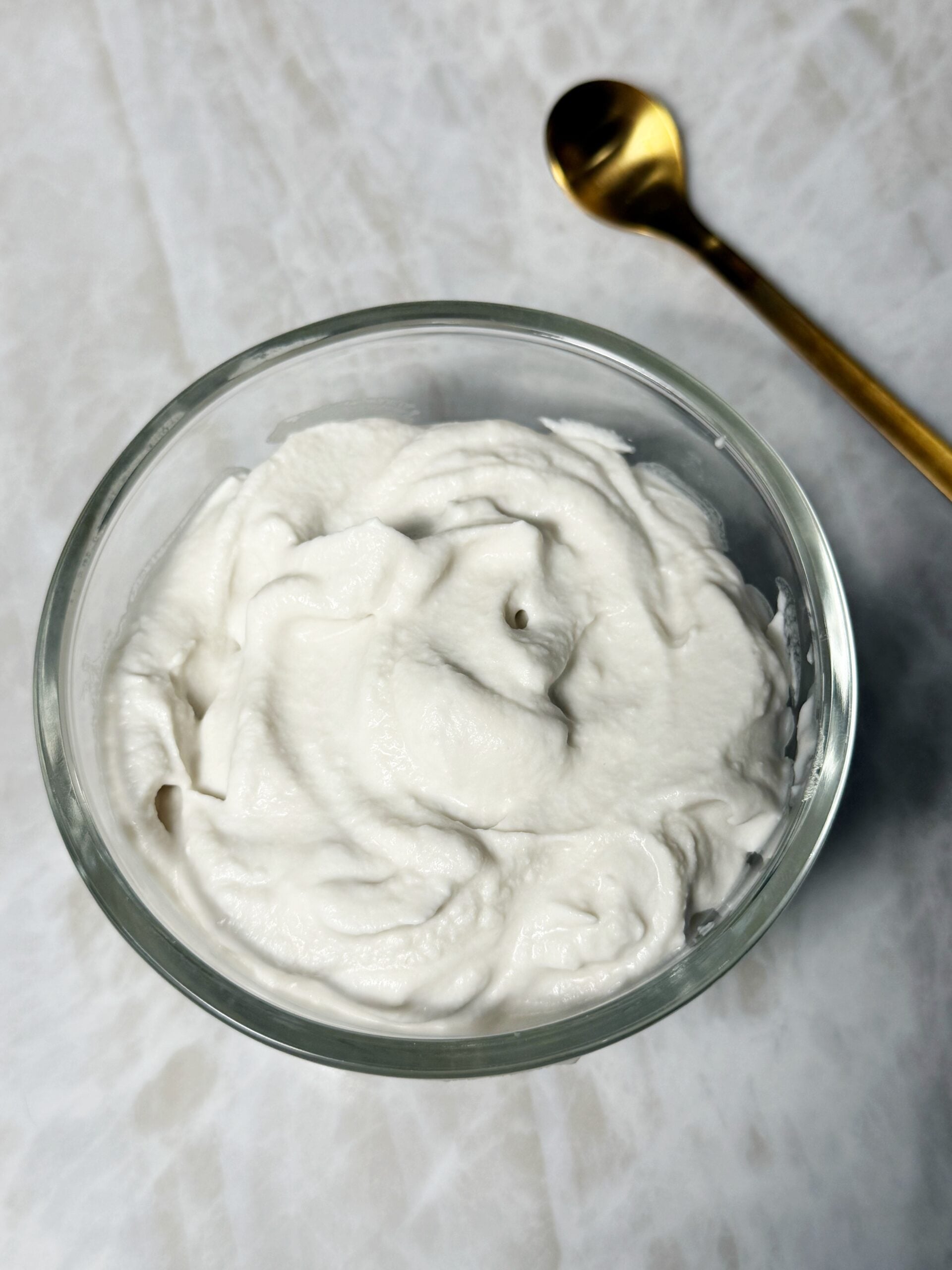 whipped cream fluffy in a bowl with a spoon 