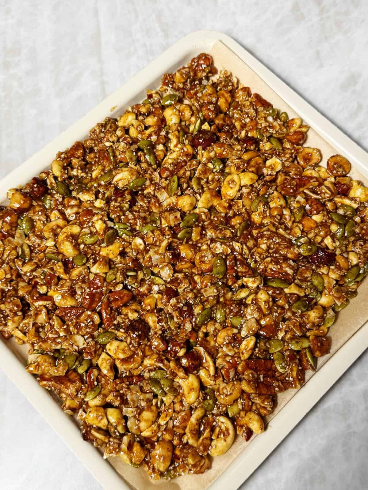 pumpkin spice granola on sheet pan ready to bake